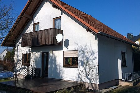 Weißes Wohnhaus vor der Fassadensanierung