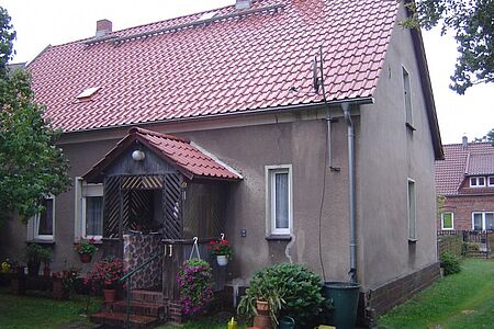 Braun verputztes Einfamilienhaus vor der Fassadensanierung
