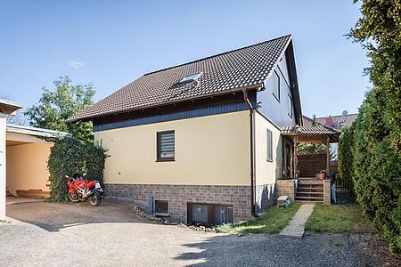 Hellgelbes Wohnhaus nach der Fassadensanierung