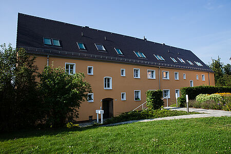 Mehrfamilienhaus mit orange gestrichener Fassade