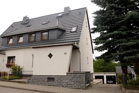 Einfamilienhaus mit frisch gestrichener Fassade in sehr hellem Rosa