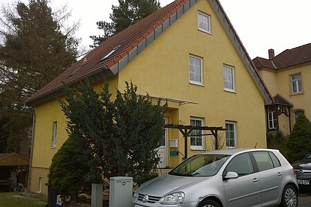 Gelbes Wohnhaus vor der Fassadensanierung 