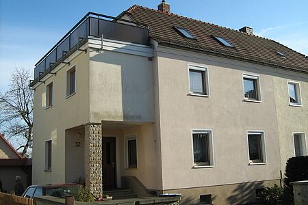 Mehrstöckiges Mehrfamilienhaus mit Balkon heller, aber schmutziger Fassade