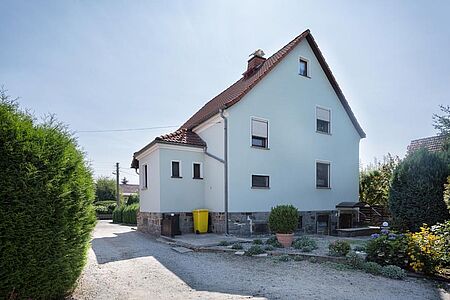 Hellblaues, dreistöckiges Wohnhaus nach der Sanierung