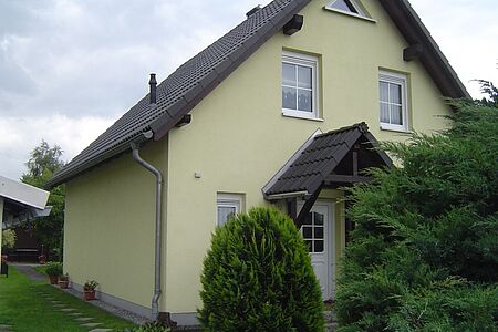 Einfamilienhaus in schmutzig-hellgrüner Fassade