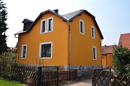 Großes Wohnhaus mit frischer Fassade in knalligem Orange