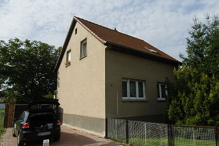 Mehrfamilienhaus mit veralteter Fassade in hellem Braun