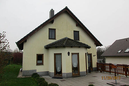 Pastellgelbes Wohnhaus mit stark verschmutzter Fassade
