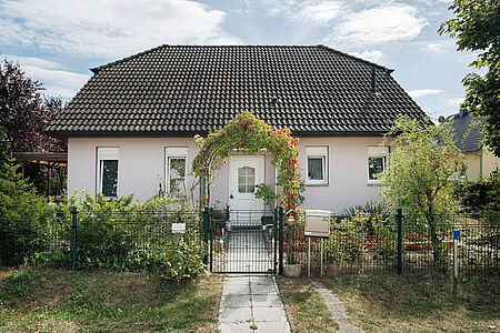 Kleines Wohnhaus mit frischer Fassade in sehr hellem Rosa