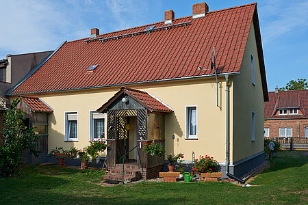 Einfamilienhaus mit frisch gestrichener, ebenmäßig gelber Fassade
