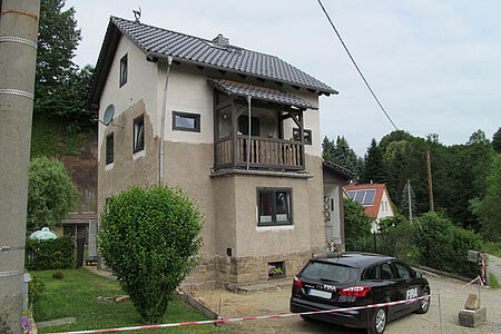 Dreistöckiges Haus mit großräumigen Stockflecken an der Fassade