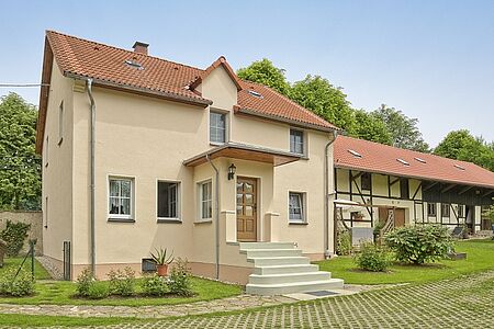 Dreistöckiges Haus mit sanierter Fassade in ebenmäßigem Beige