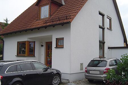 Einfamilienhaus mit leicht verschmutzter weißer Fassade